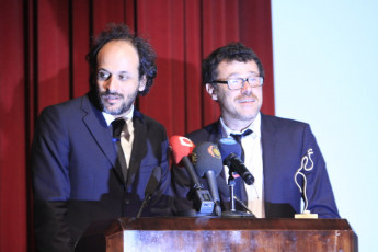 Luca Guadagnino giving a word, beside him his producer Carlo Antonella