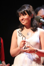 Nora Niasiri receiving her frist prize for Best Director for Documentary for “UNDER THE BRIDGE”
